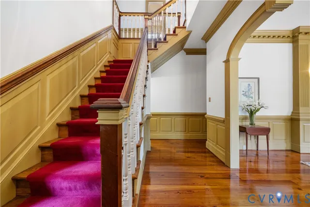a view of entryway and hall with wooden floor