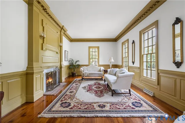 a living room with fireplace furniture and a window