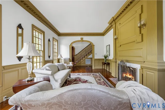 a bedroom with a bed a couch and dresser next to a window