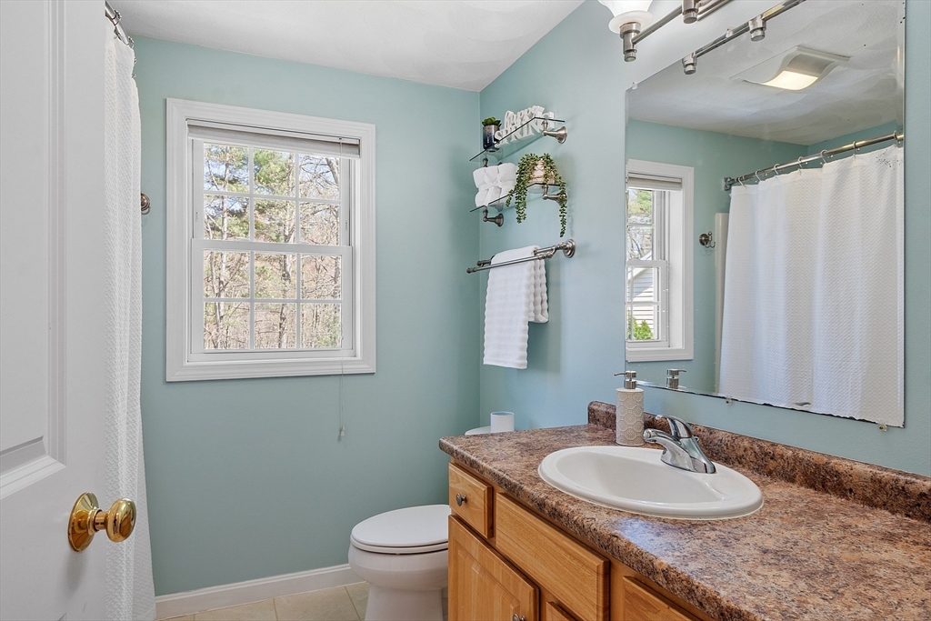 107 Charant Road Lowell, MA 01854 - Photo 15 of 30 a bathroom with a granite countertop sink and a mirror