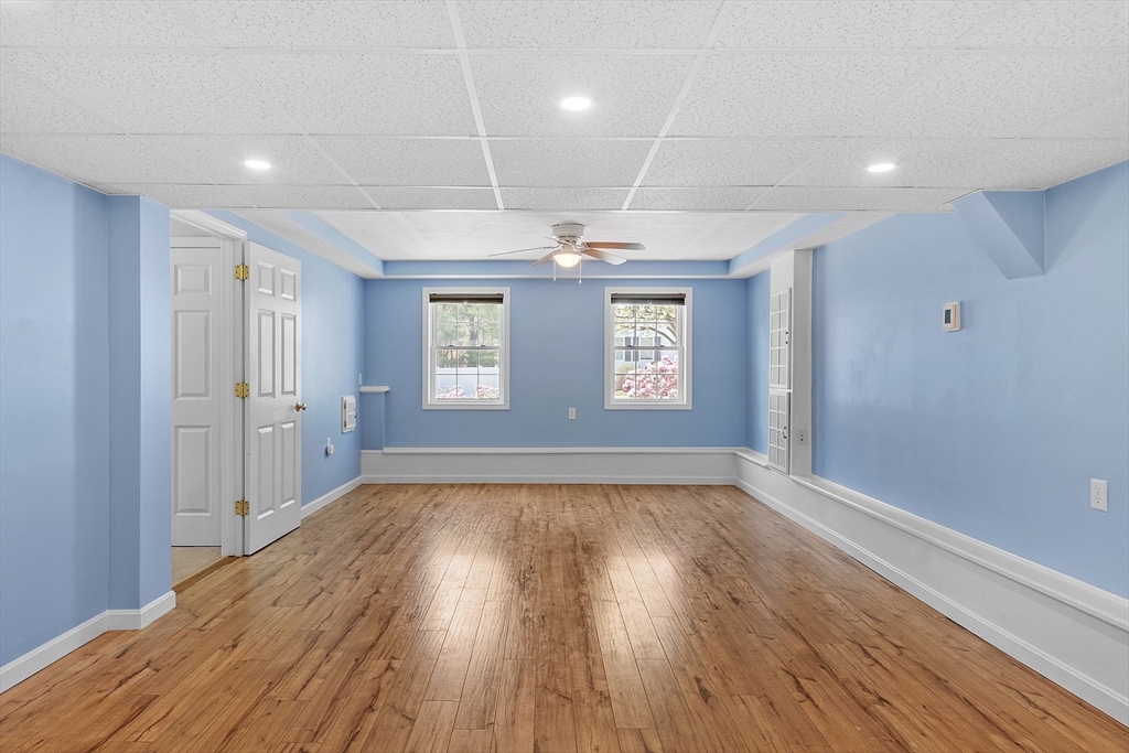 107 Charant Road Lowell, MA 01854 - Photo 20 of 30 a view of an empty room with wooden floor and a window