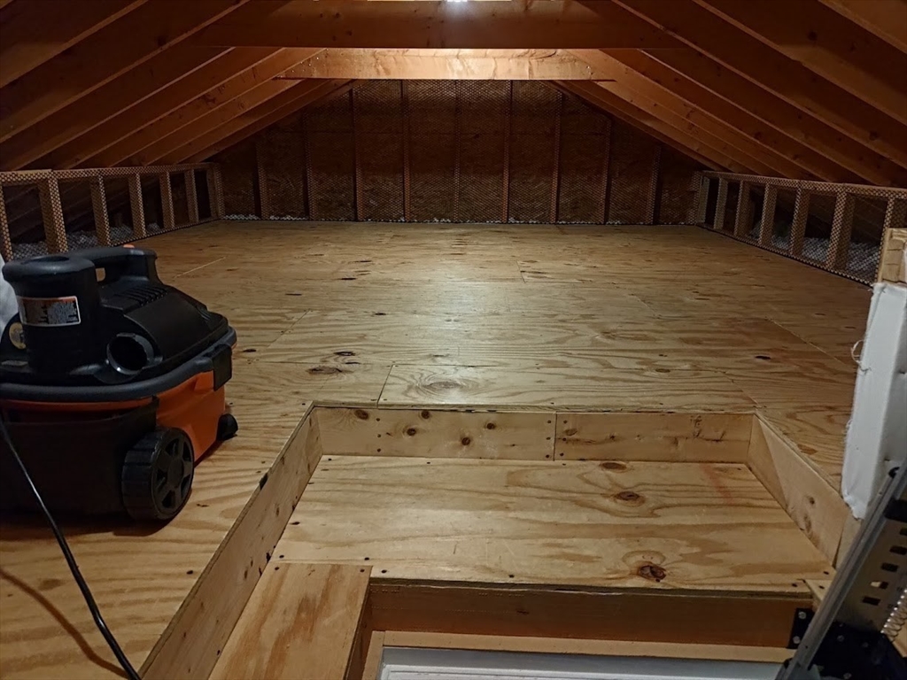 107 Charant Road Lowell, MA 01854 - Photo 24 of 30 a room with water heater and wooden cabinets