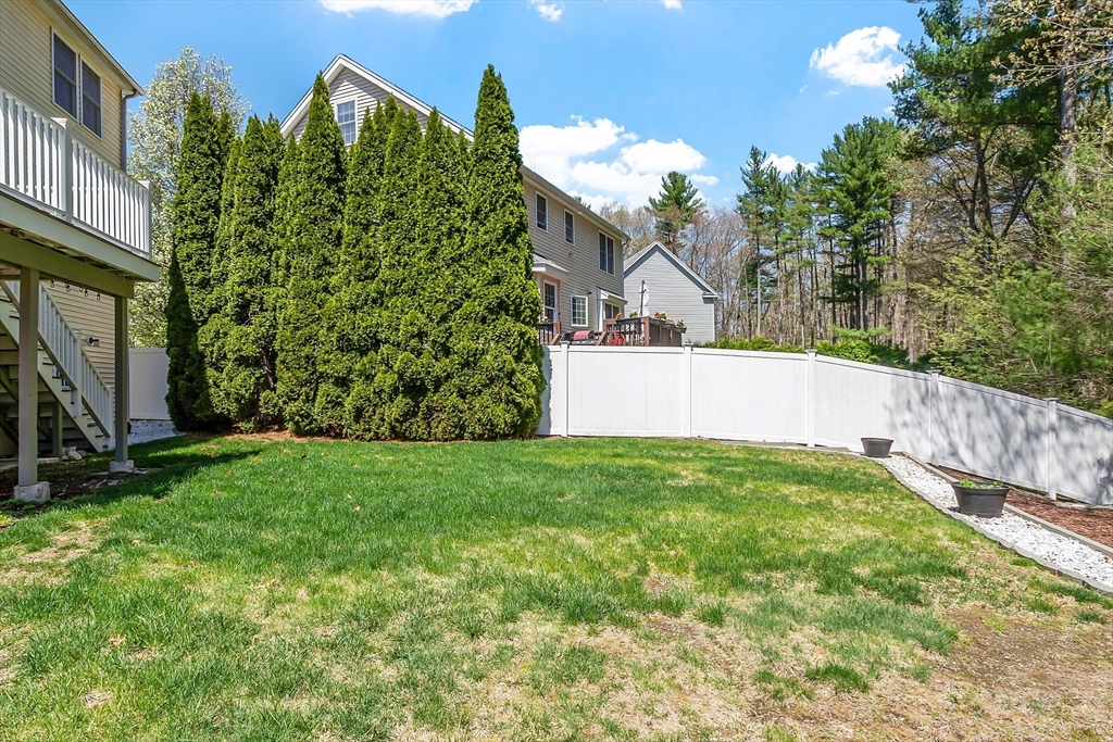 107 Charant Road Lowell, MA 01854 - Photo 26 of 30 a view of a backyard with plants and large trees