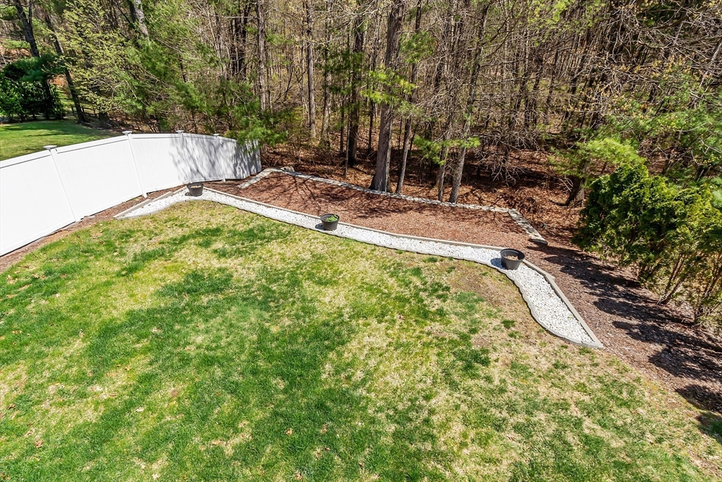107 Charant Road Lowell, MA 01854 - Photo 27 of 30 a view of a backyard with a small pool and sitting area