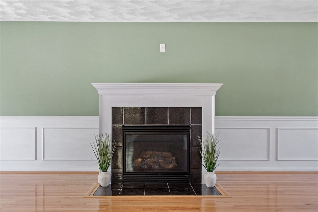 107 Charant Road Lowell, MA 01854 - Photo 3 of 30 a fireplace