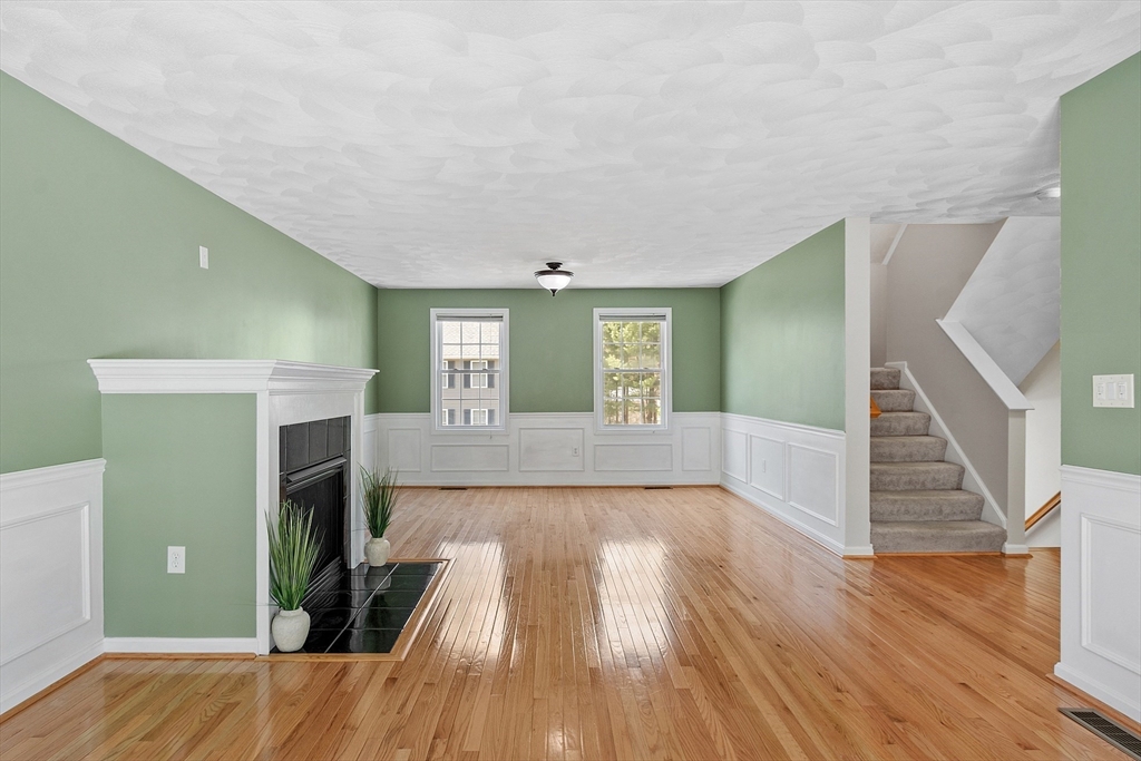107 Charant Road Lowell, MA 01854 - Photo 4 of 30 a view of livingroom with hardwood floor and fireplace