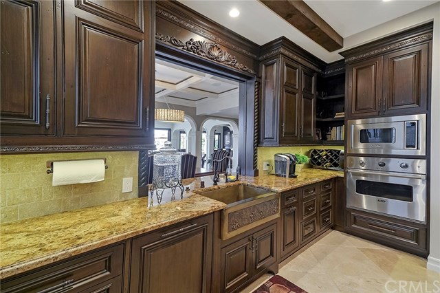 3 Harbor Island Newport Beach, CA 92660 - Photo 8 of 73 The remodeled kitchen was thoughtfully planned with extensive storage, refrigeration, three ovens, warming drawer, and six-burner gas cooktop with grill.
