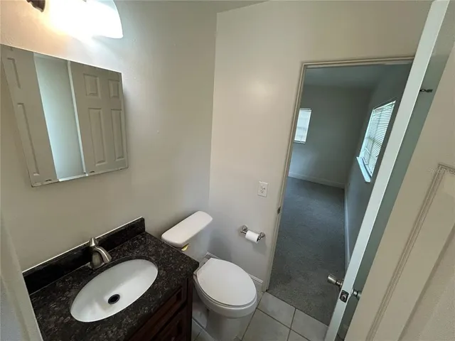 a view of a hallway with wooden floor and stairs