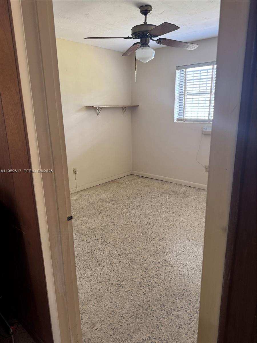 1270 West 31st Street Hialeah, FL 33012 - Photo 9 of 12 en empty room with windows and fan