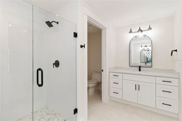a bathroom with a double vanity sink and mirror with shower