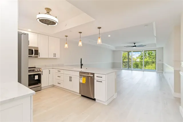 a kitchen with stainless steel appliances granite countertop a stove and a sink