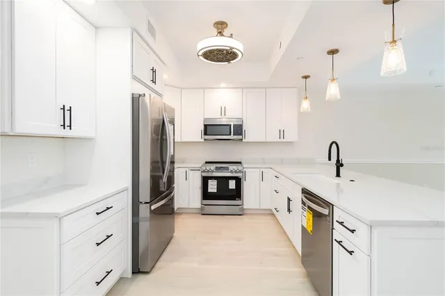 a kitchen with stainless steel appliances granite countertop a stove and a refrigerator