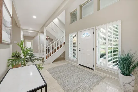 a view of an entryway with wooden floor and door