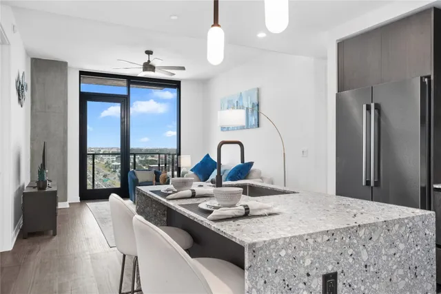 a kitchen with a table chairs and a chandelier