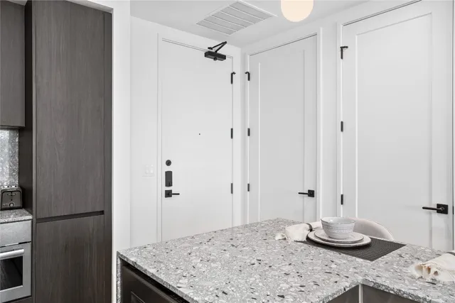a bathroom with a granite countertop sink a shower and a mirror
