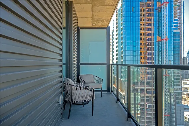 a view of a balcony with chairs