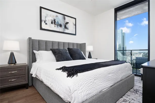 a bedroom with bed and painting on the wall