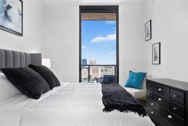 a bedroom with a bed and painting on the wall