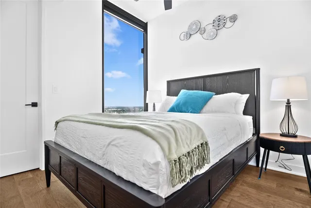 a bedroom with a bed and a night stand