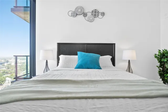 a large bed sitting in a bedroom next to a window