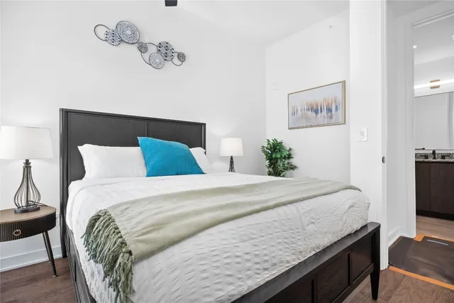 a bedroom with a bed and a flat screen tv