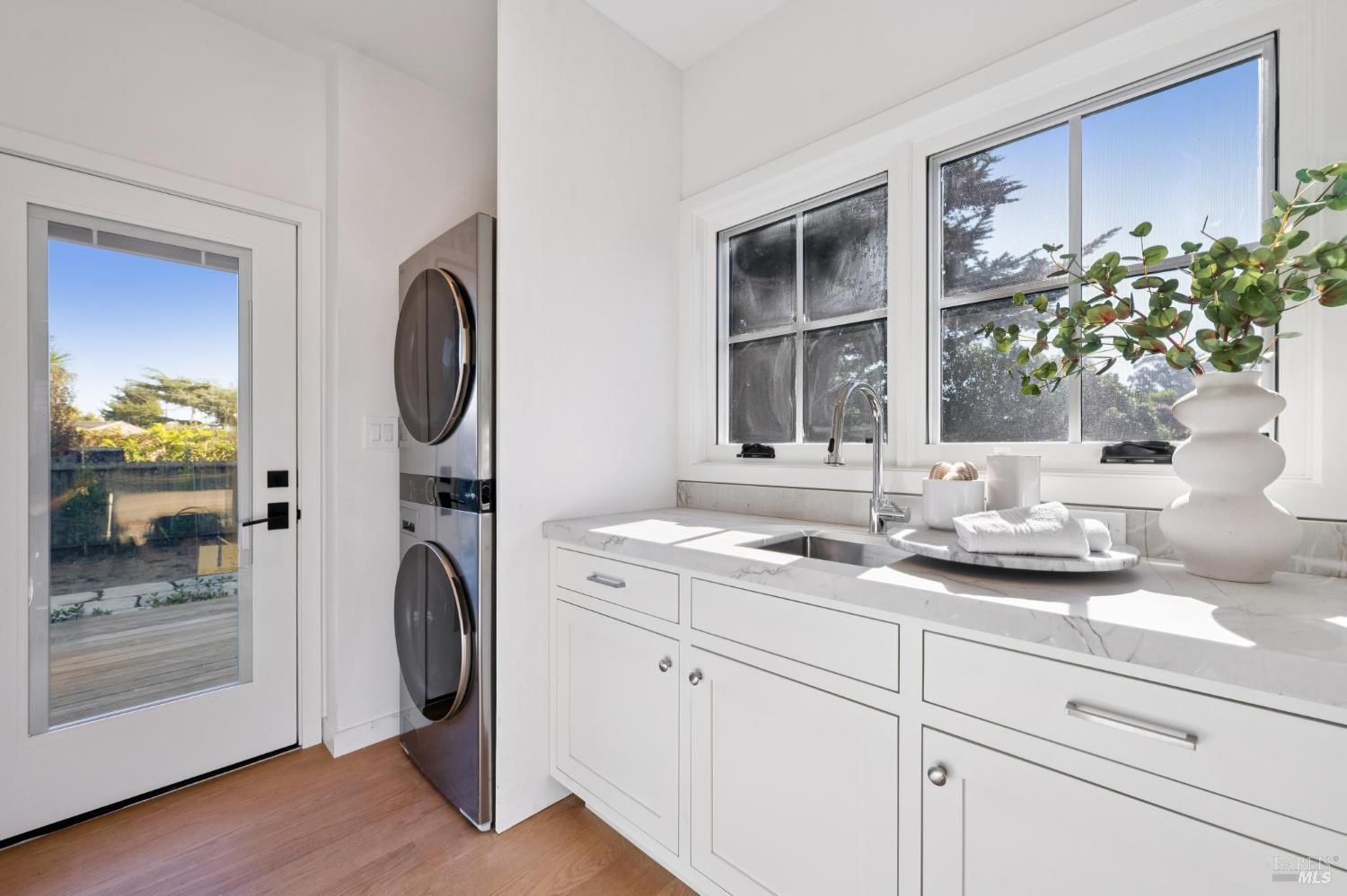 185 Elm Road Bolinas, CA 94924 - Photo 26 of 43 a bathroom with a granite countertop sink and a mirror