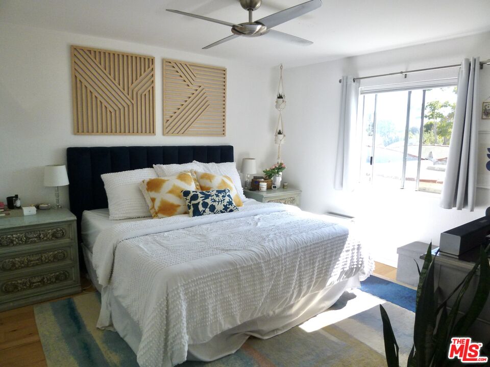 717 Crestmoore Place Venice, CA 90291 - Photo 13 of 18 a bedroom with a bed and wooden floor