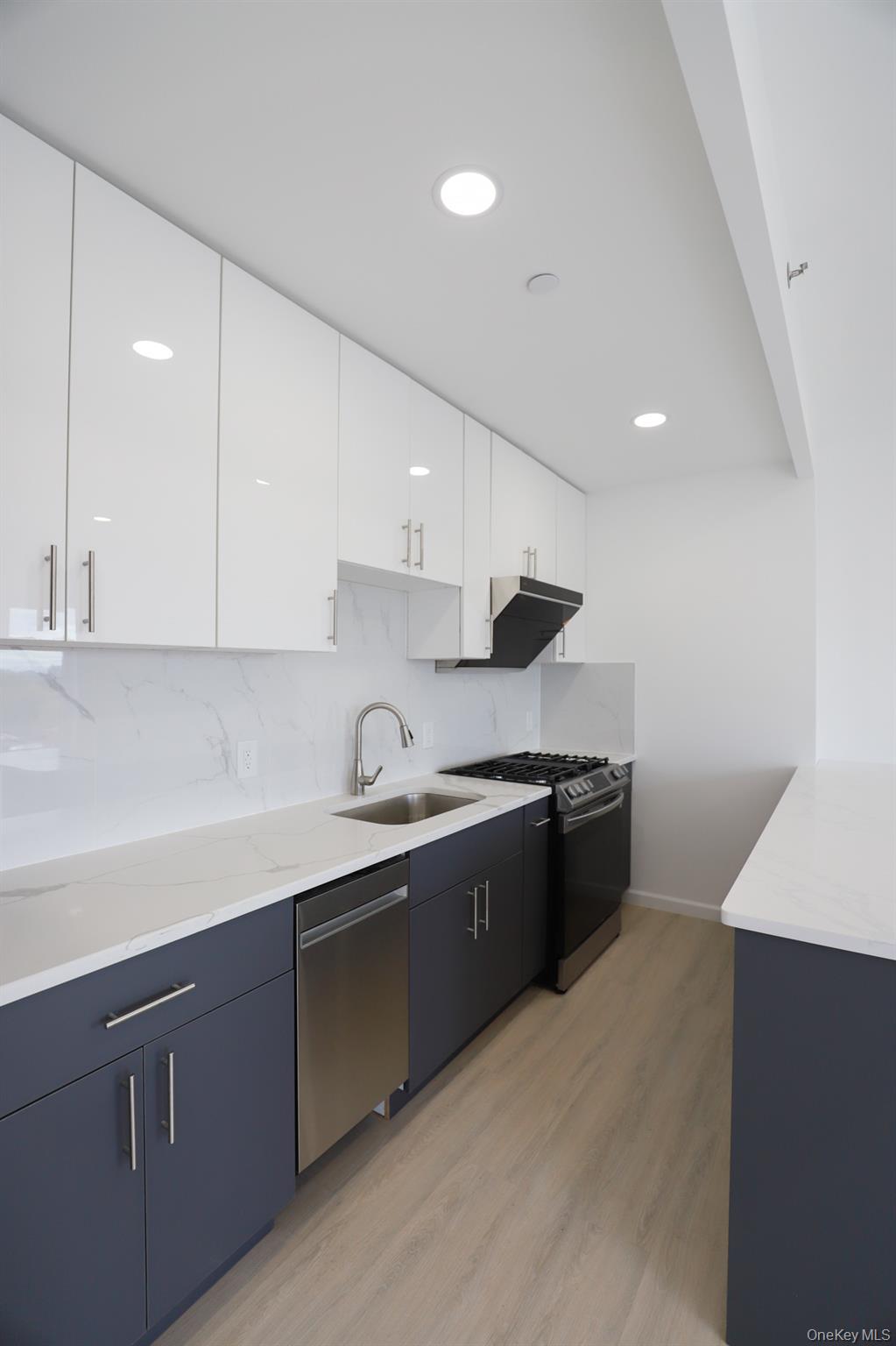 42-78 Main Street, Unit 6E Queens, NY 11355 - Photo 11 of 33 a kitchen with stainless steel appliances granite countertop a sink and stove top oven