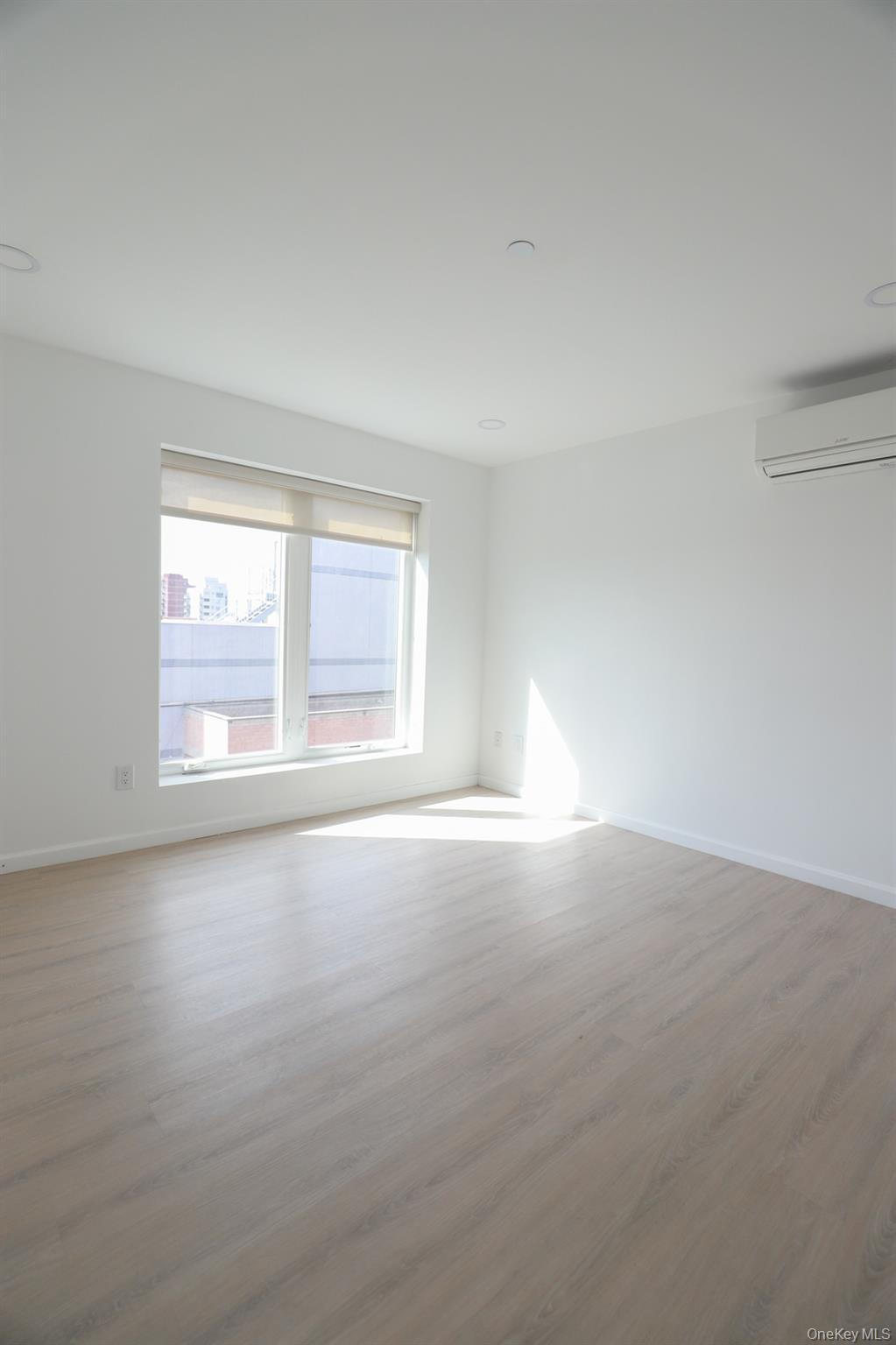 42-78 Main Street, Unit 6E Queens, NY 11355 - Photo 14 of 33 an empty room with a empty space and windows