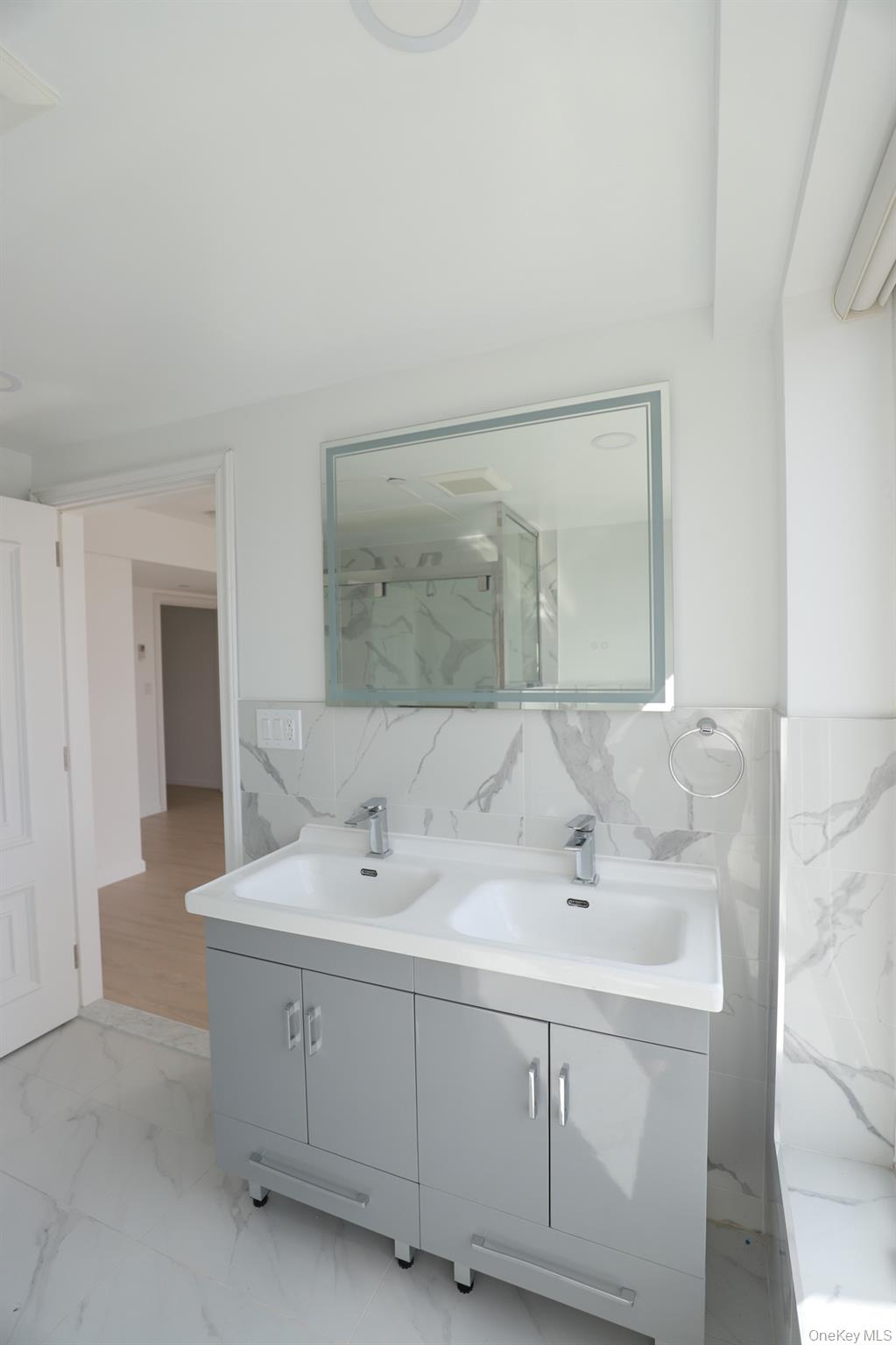 42-78 Main Street, Unit 6E Queens, NY 11355 - Photo 15 of 33 a bathroom with a sink and a mirror