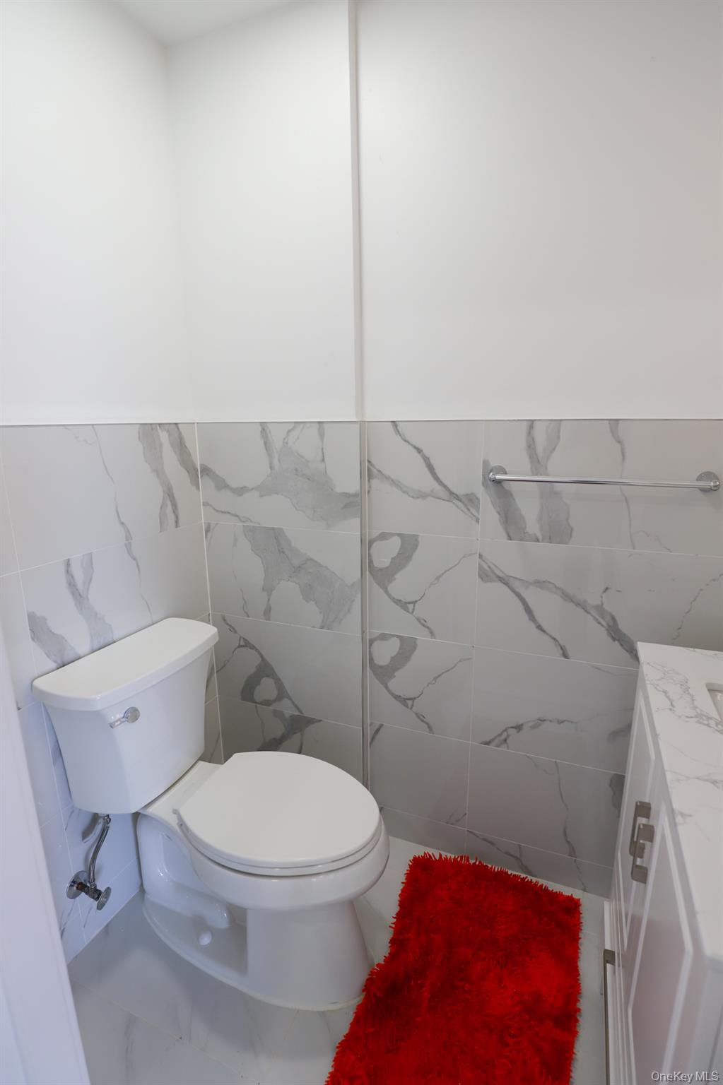 42-78 Main Street, Unit 6E Queens, NY 11355 - Photo 16 of 33 a white toilet sitting next to a shower and a sink