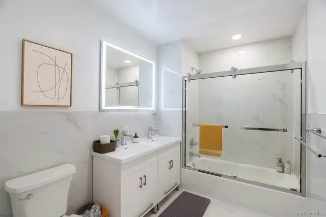 a kitchen with stainless steel appliances granite countertop a sink a stove a refrigerator and a microwave