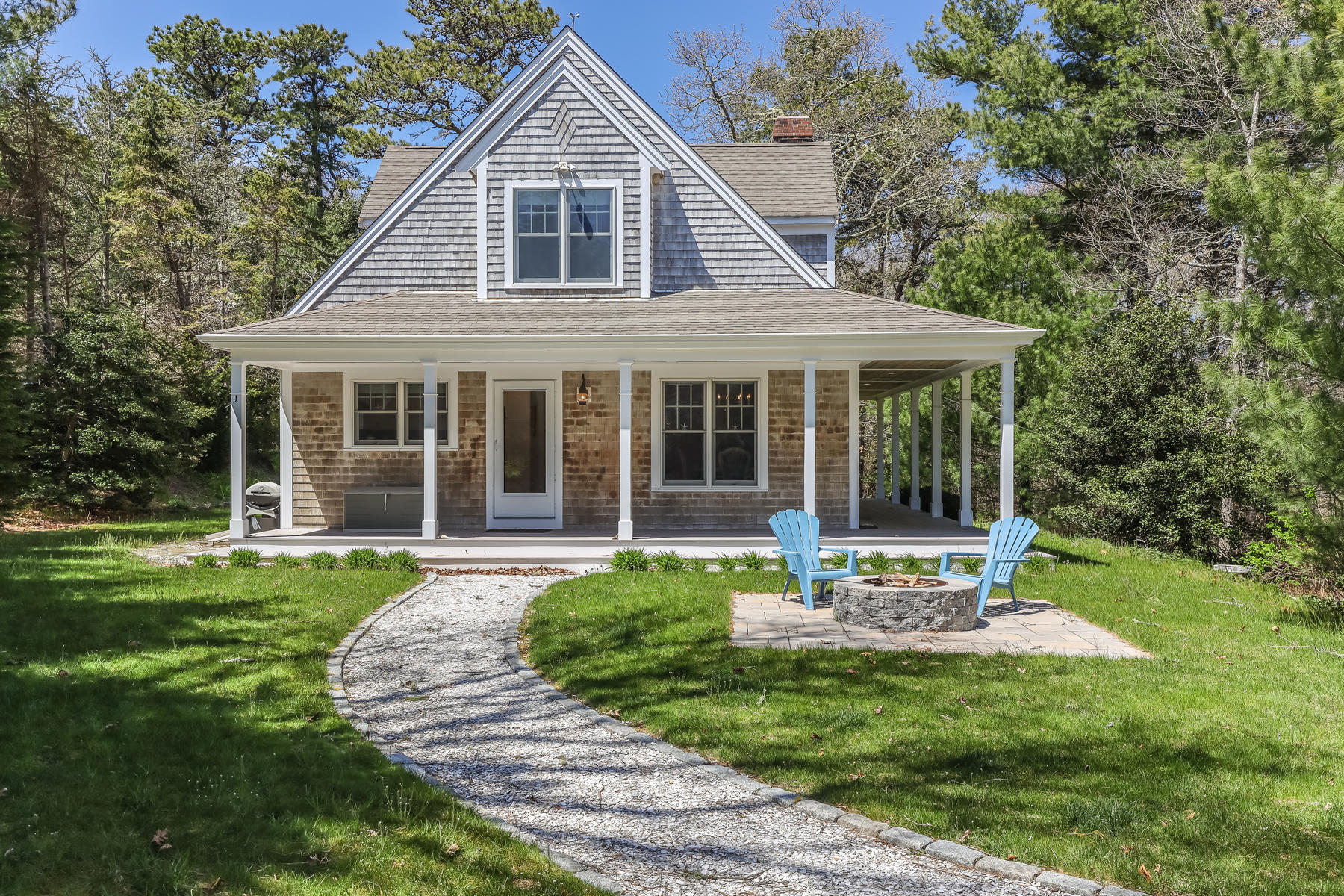 50 Pheasant Way, Unit A&B Centerville, MA 02632 - Photo 2 of 62 a front view of a house with a yard table and chairs