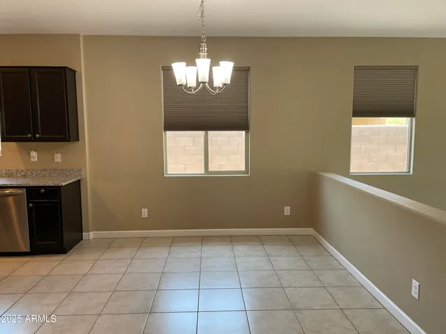 view of an empty room with a fireplace and a window