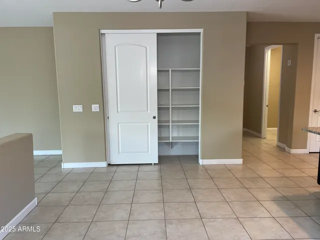 a view of an empty room and closet area