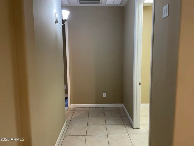 a view of an empty room with a mirror