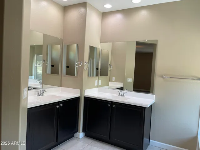 a bathroom with a double vanity sink and a mirror