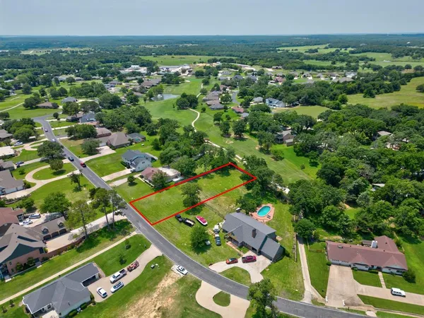 an aerial view of residential houses with outdoor space and river
