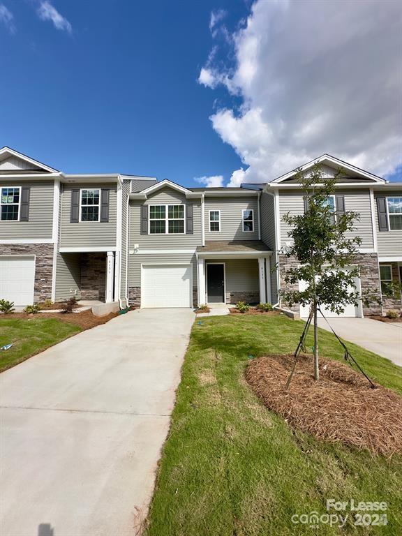6135 Faron Way Charlotte, NC 28262 - Photo 1 of 23 a front view of a house with a yard and garage