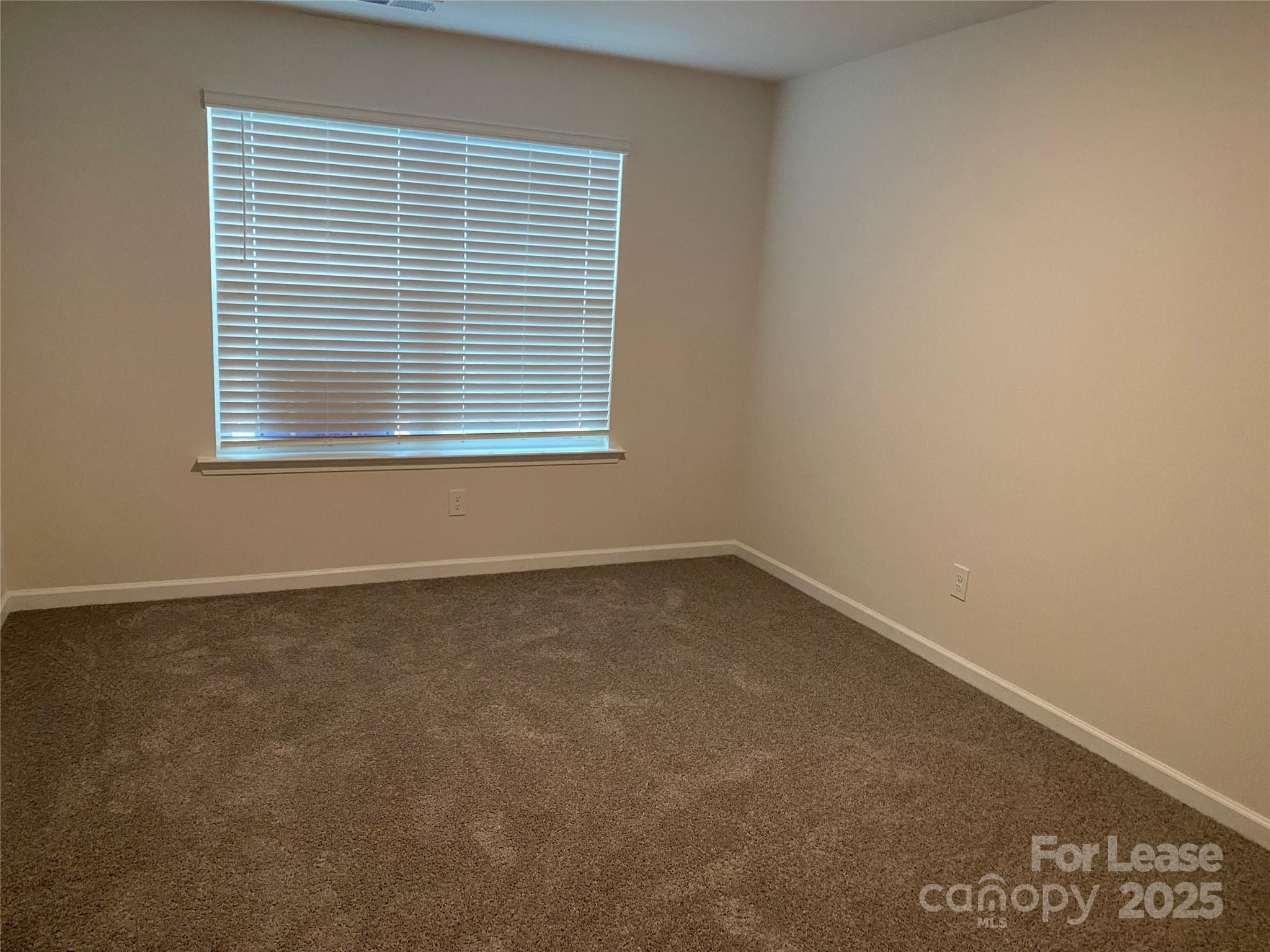 6135 Faron Way Charlotte, NC 28262 - Photo 11 of 23 an empty room with a window
