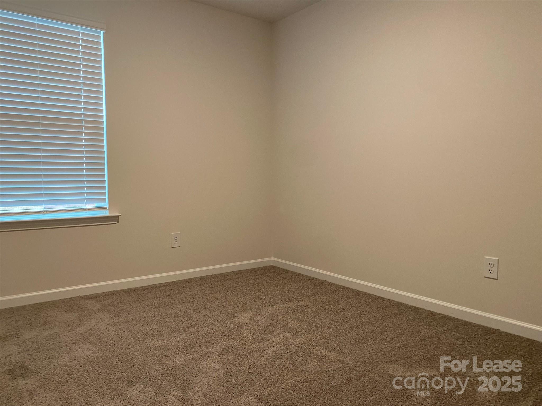 6135 Faron Way Charlotte, NC 28262 - Photo 14 of 23 an empty room with a window