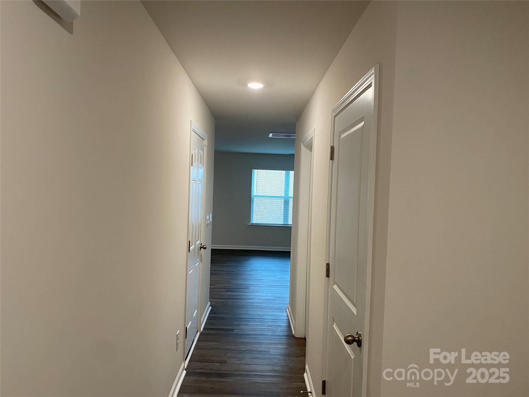 6135 Faron Way Charlotte, NC 28262 - Photo 18 of 23 a view of a hallway with wooden floor and staircase