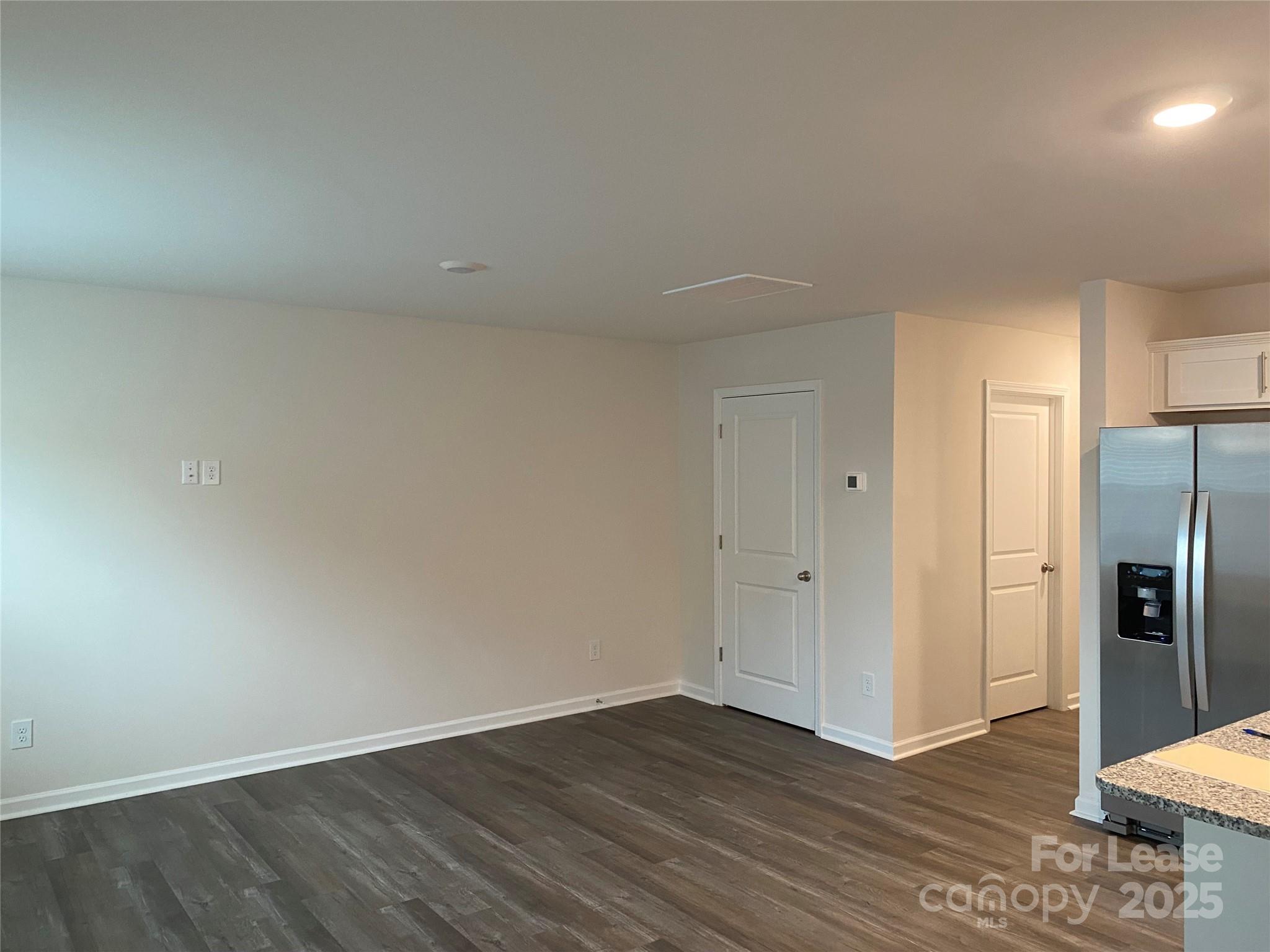 6135 Faron Way Charlotte, NC 28262 - Photo 20 of 23 a view of an empty room with wooden floor and a cabinet