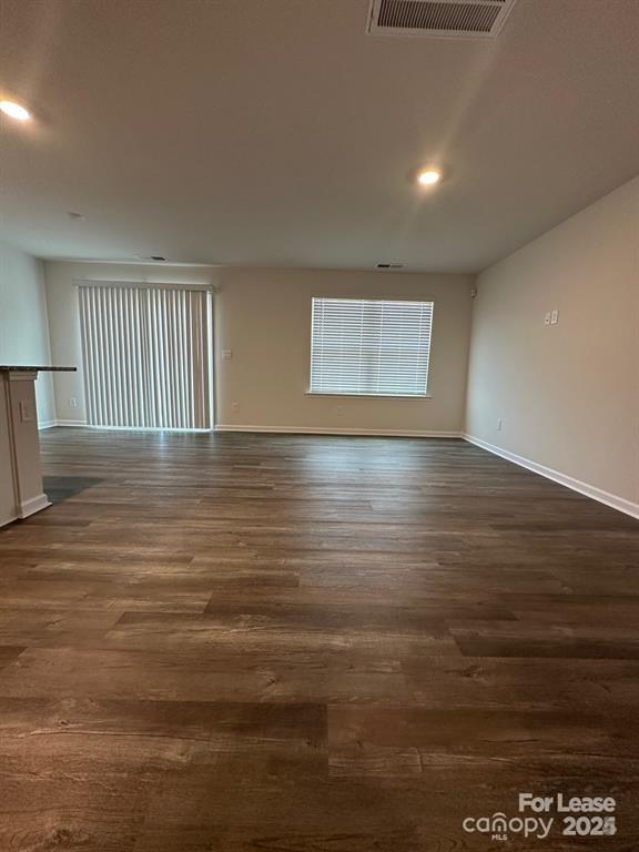 6135 Faron Way Charlotte, NC 28262 - Photo 22 of 23 a view of an empty room with wooden floor