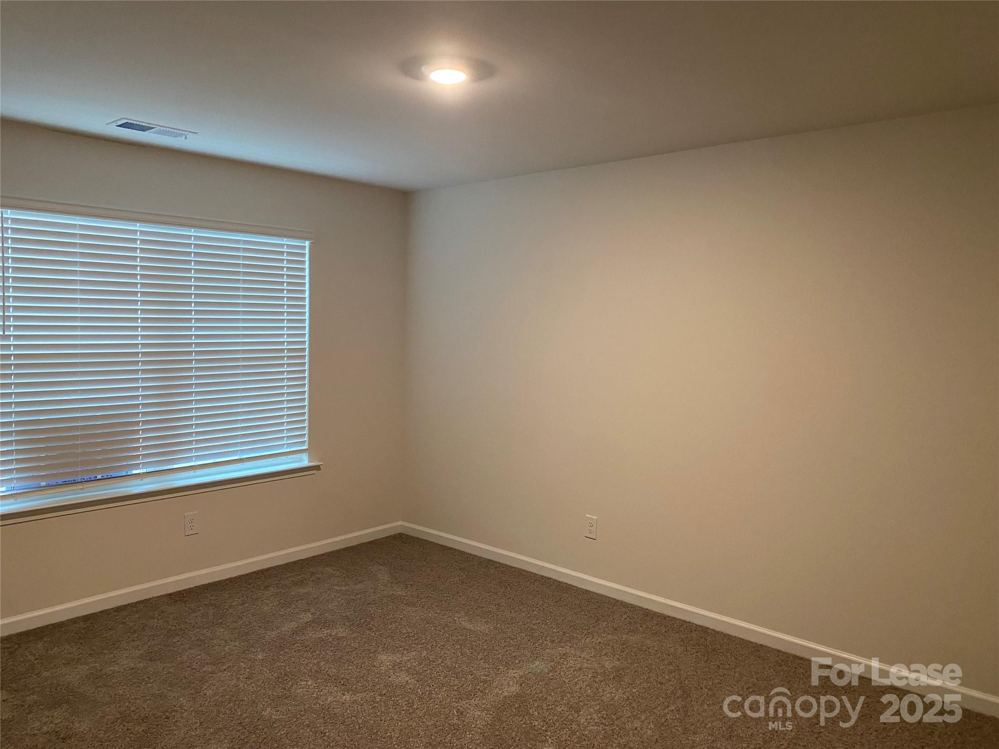 6135 Faron Way Charlotte, NC 28262 - Photo 10 of 23 an empty room with a window