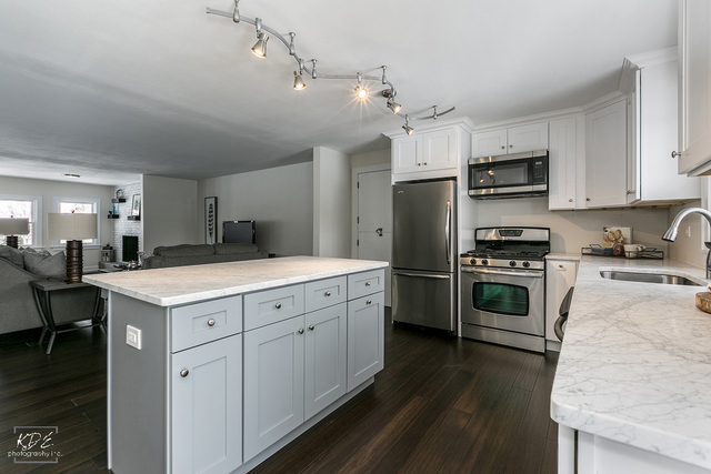 12N234 South Randall Road Elgin, IL 60123 - Photo 12 of 33 a kitchen with a stove a sink and a refrigerator