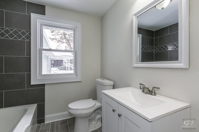 12N234 South Randall Road Elgin, IL 60123 - Photo 18 of 33 a bathroom with a toilet sink and mirror