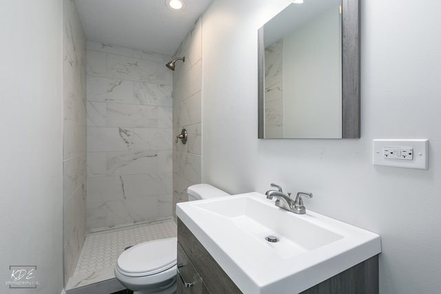 12N234 South Randall Road Elgin, IL 60123 - Photo 26 of 33 a bathroom with a sink a toilet and shower