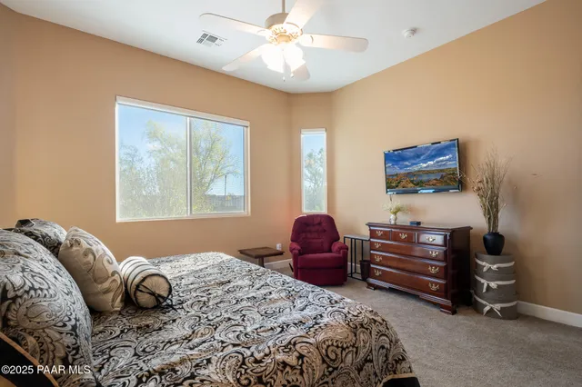 a bedroom with a bed dresser and a window