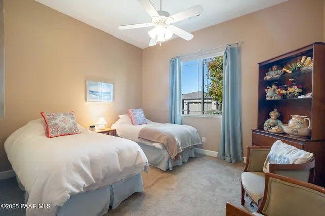 a bedroom with two beds and a painting on the wall
